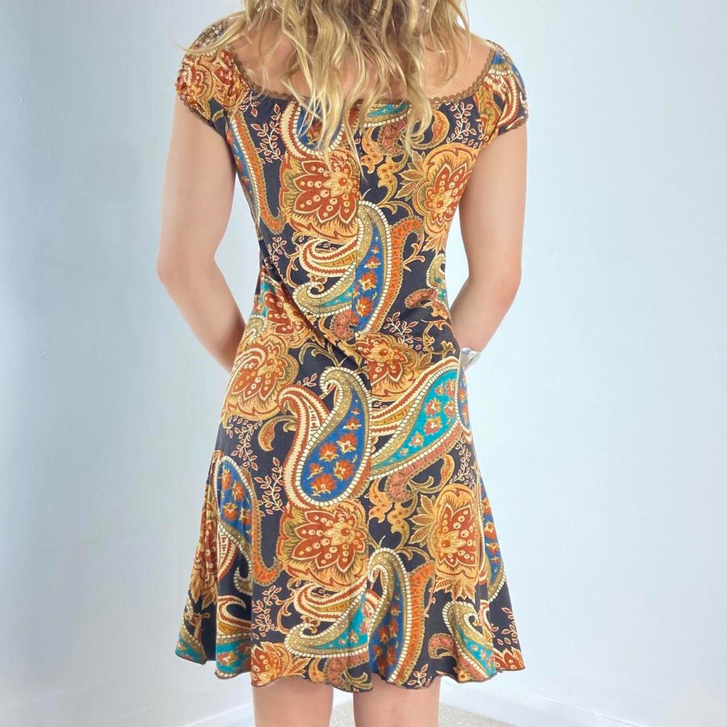 Beautiful black dress with orange,yellow and green graphic paisley patterning and a milkmaid cut- ties with a little bow