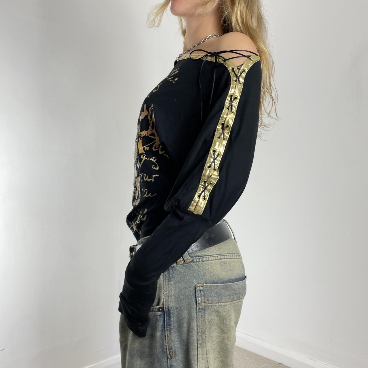 Off-the-shoulder gold and black graphic batwing top
