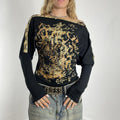 Off-the-shoulder gold and black graphic batwing top