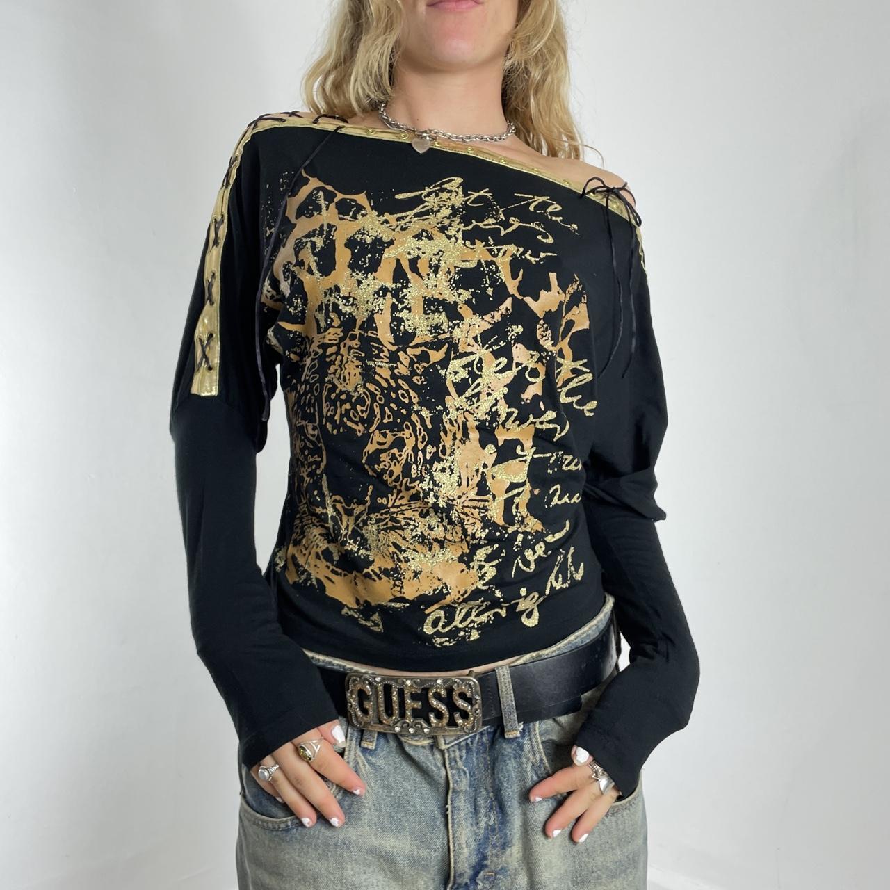 Off-the-shoulder gold and black graphic batwing top