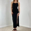 Fitted black evening dress with a split in the leg