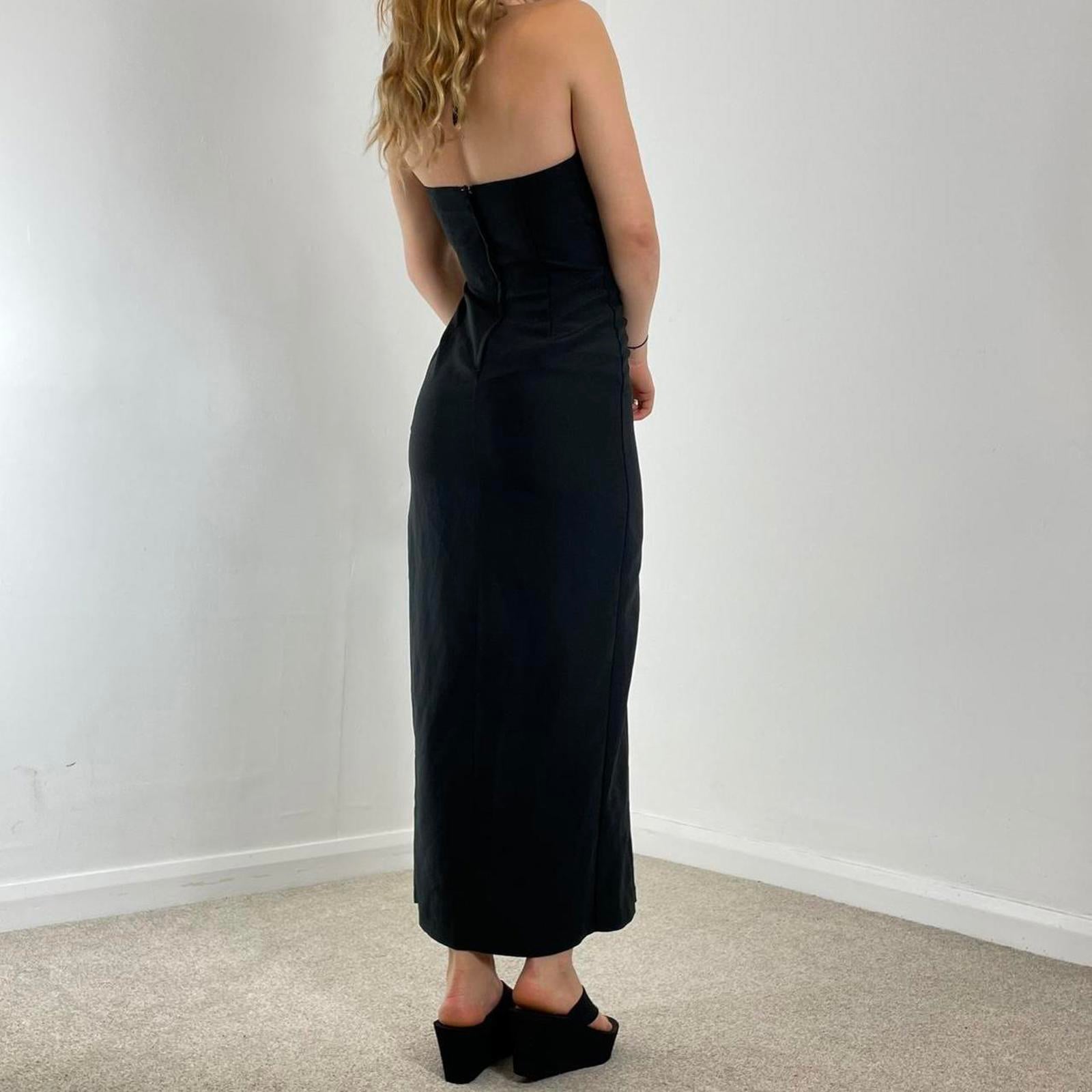 Fitted black evening dress with a split in the leg