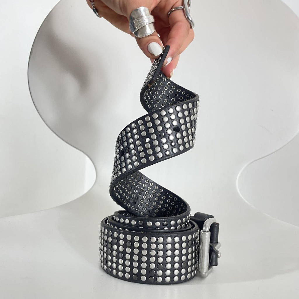 Studded silver belt on black leather