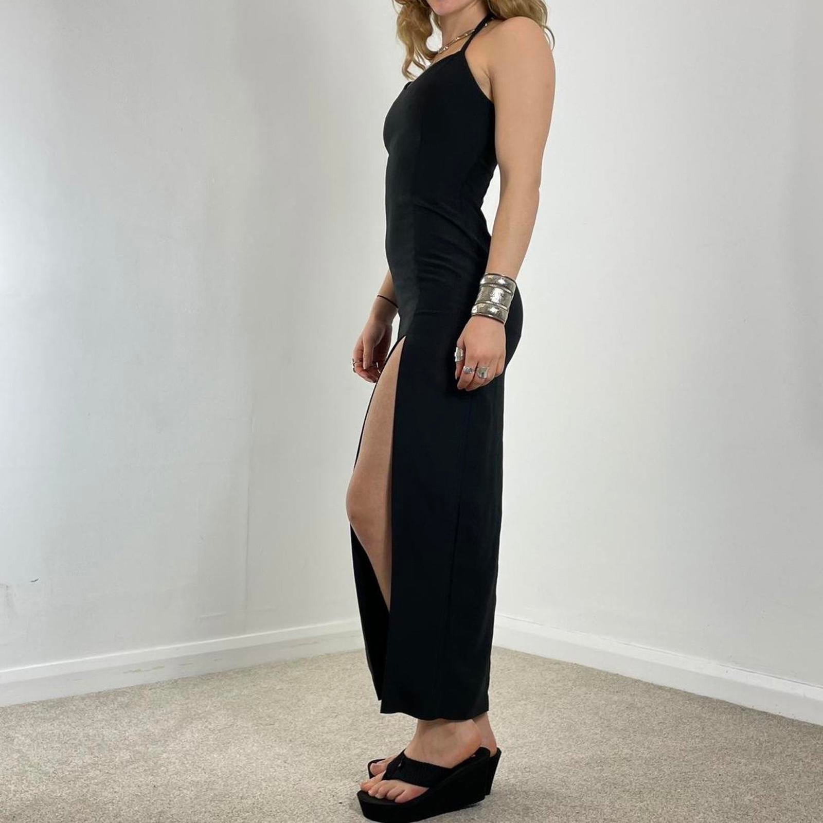 Fitted black evening dress with a split in the leg