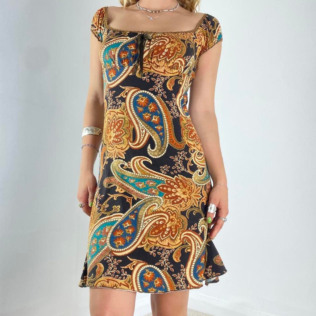 Beautiful black dress with orange,yellow and green graphic paisley patterning and a milkmaid cut- ties with a little bow