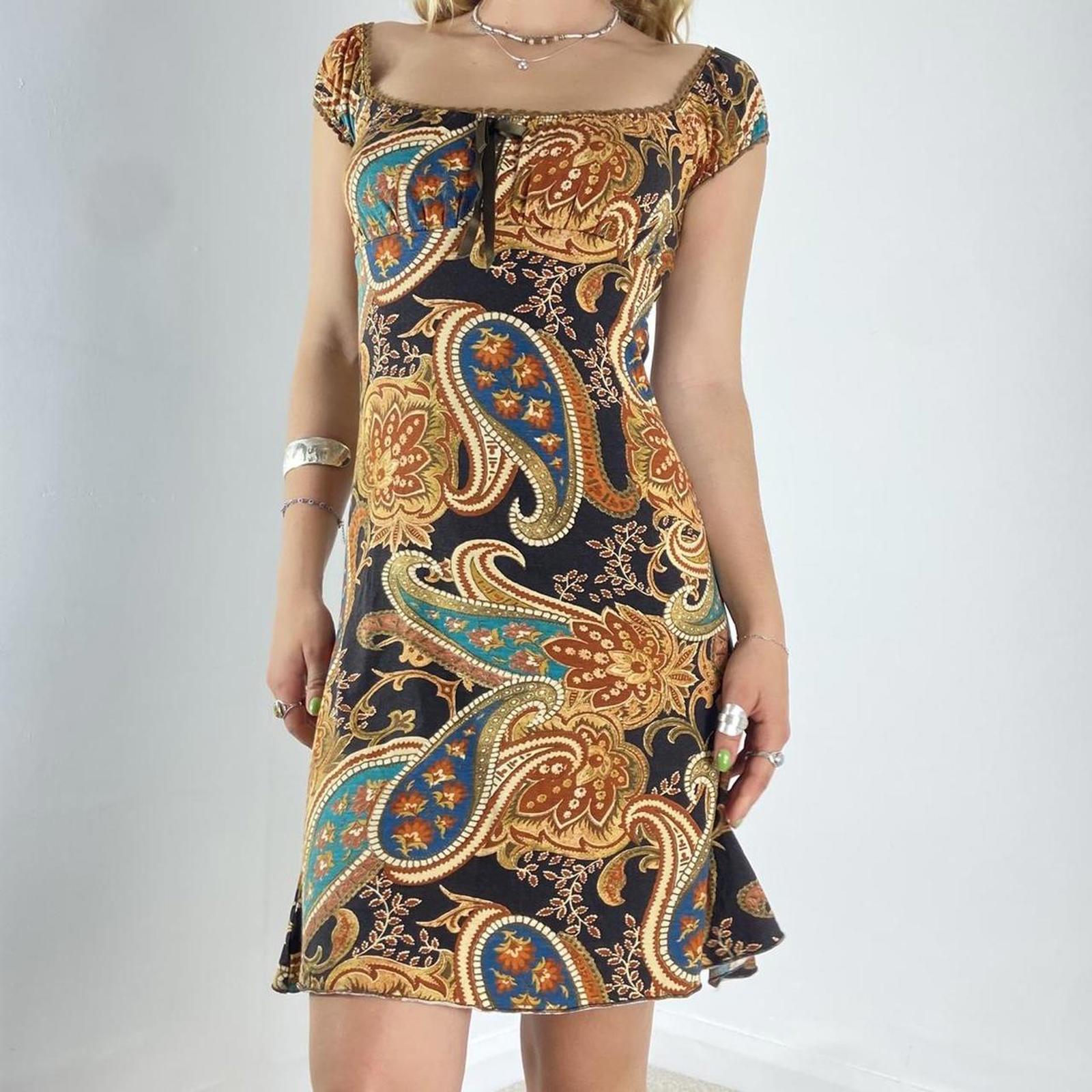 Beautiful black dress with orange,yellow and green graphic paisley patterning and a milkmaid cut- ties with a little bow