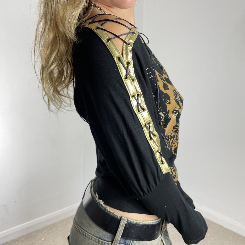 Off-the-shoulder gold and black graphic batwing top