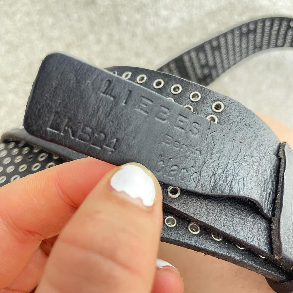 Studded silver belt on black leather