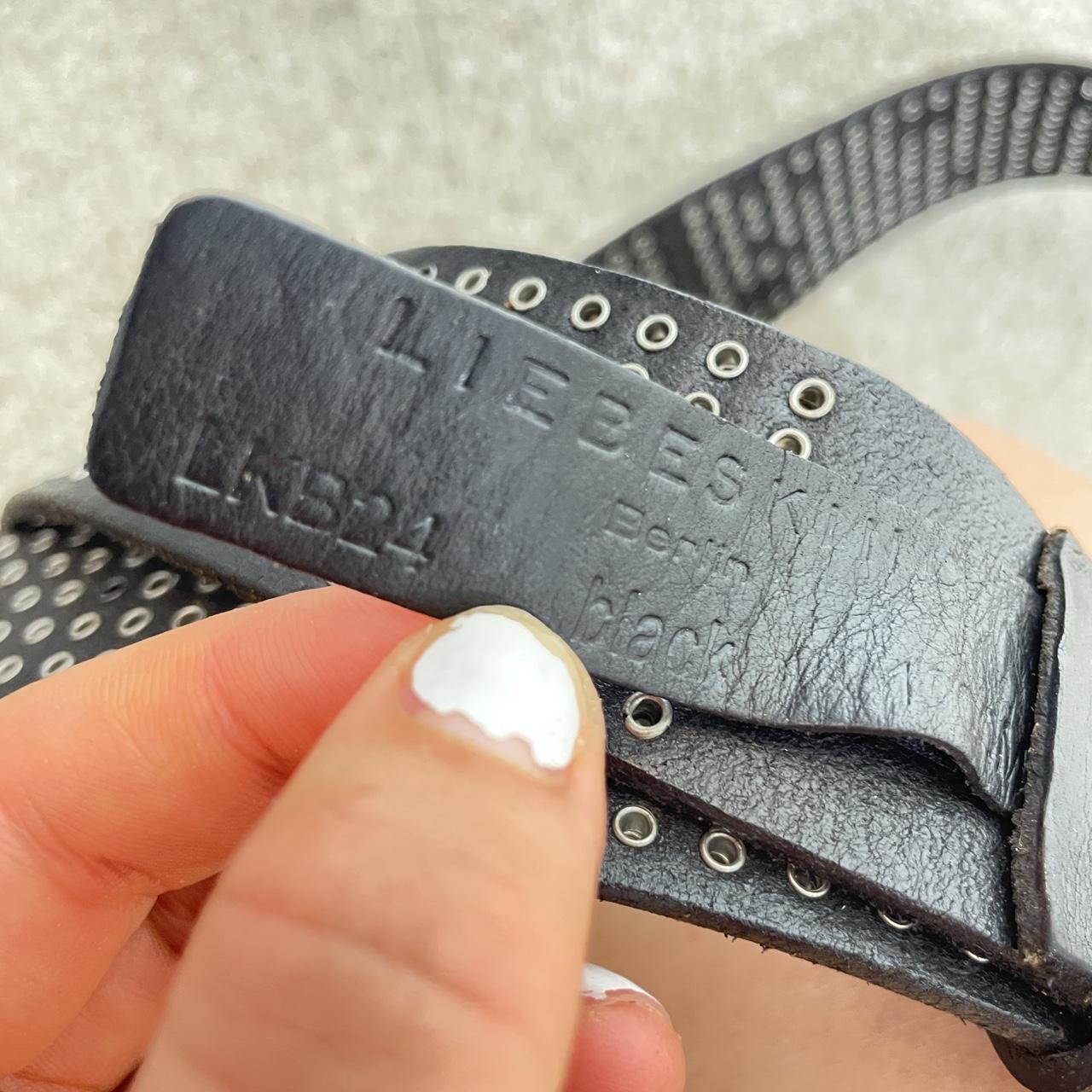 Studded silver belt on black leather